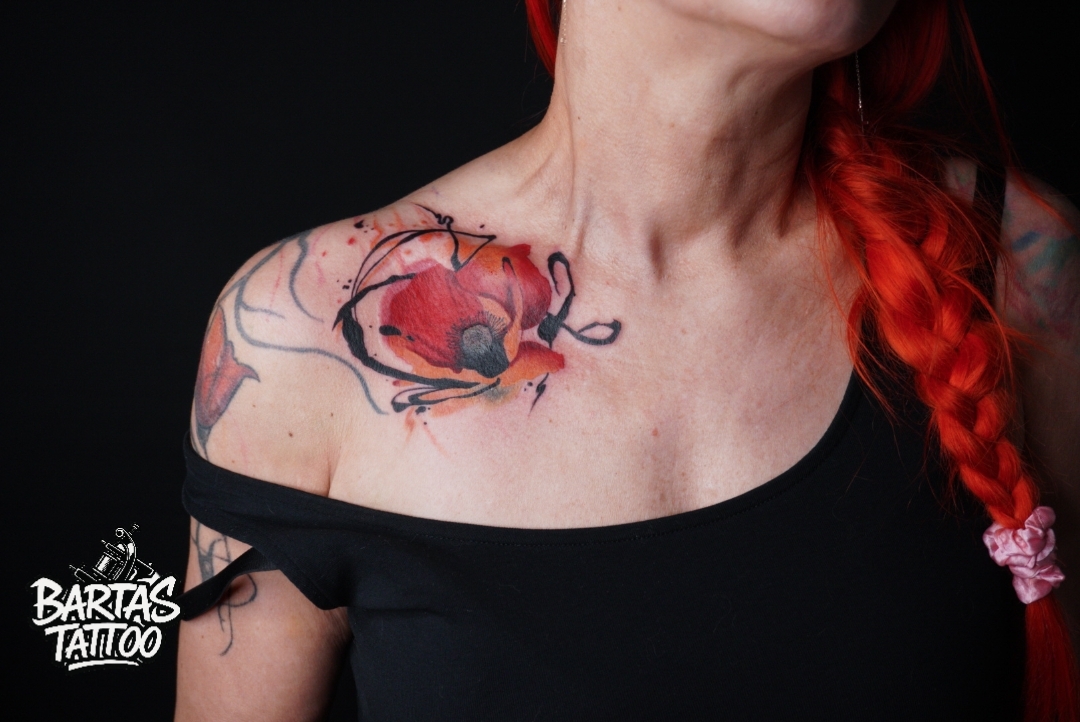 Watercolour poppy flower tattoo on a shoulder